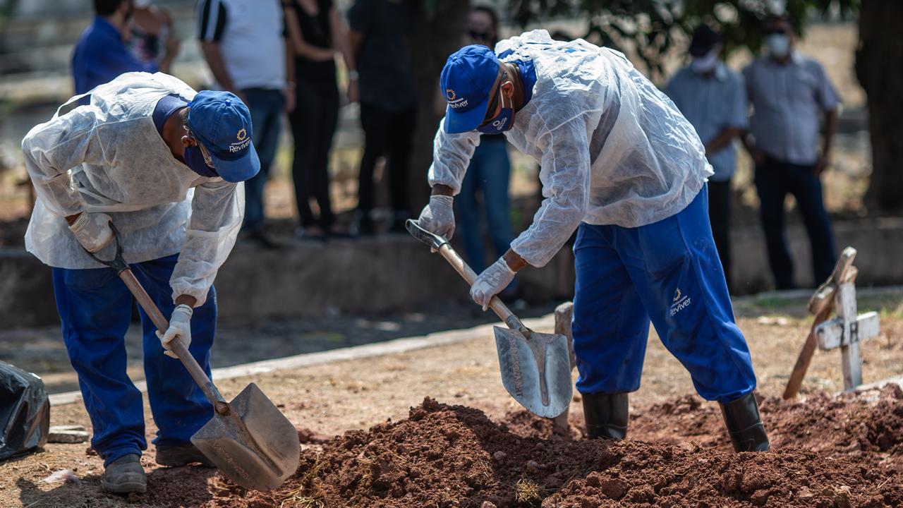 Gravediggers at work at the Sao Francisco Xavier cemetery on December 16 in Rio de Janeiro, Brazil. The city has become the new epicentre of the COVID-19 coronavirus pandemic in Brazil, with 565 deaths in just two weeks. Picture: Andre Coelho/Getty Images