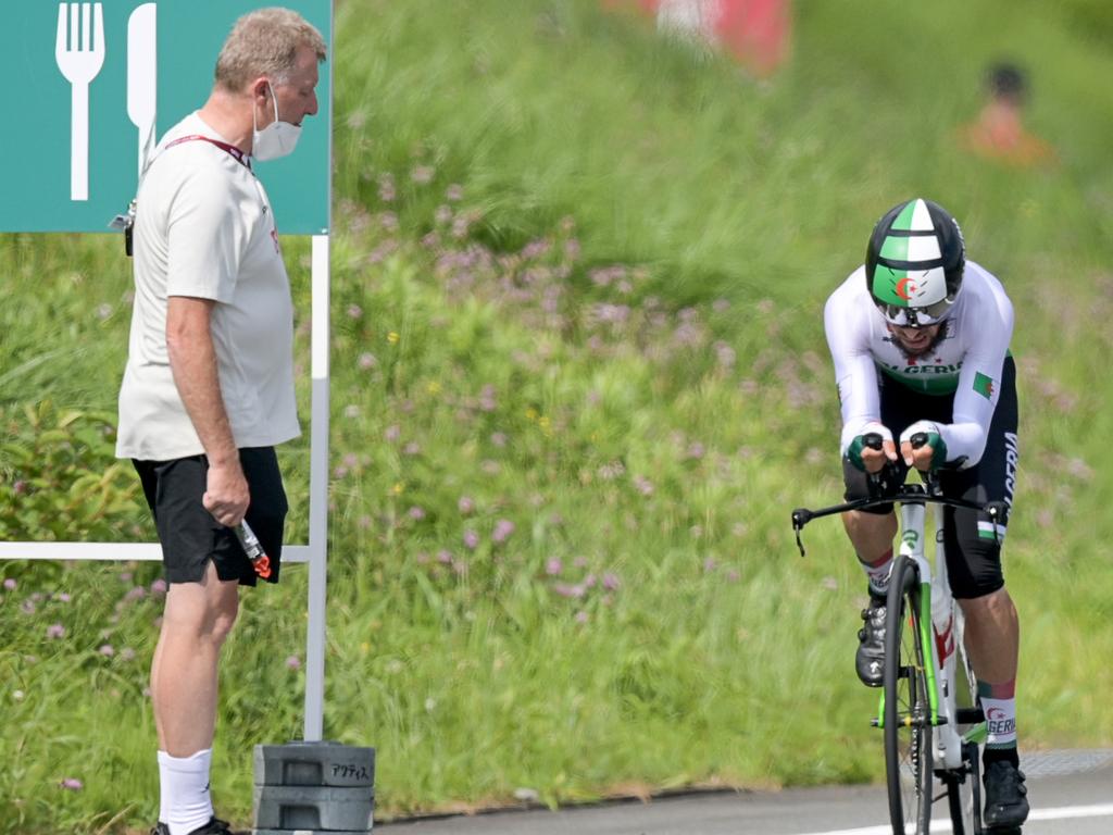 29 July 2021, Japan, Oyama: Cycling: Olympics, Oyama (22.10km), men, individual time trial at Fuji International Speedway. Patrick Moster, Sports Director of the BDR (German Cycling Federation), stands on the side of the track next to Azzedine Lagab from Algeria in action during the time trial. Photo: Sebastian Gollnow/dpa (Photo by Sebastian Gollnow/picture alliance via Getty Images)