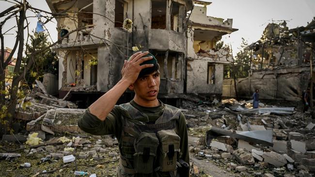 An Afghan soldier stands guard at the site of a car bomb explosion in Kabul. Picture: AFP.