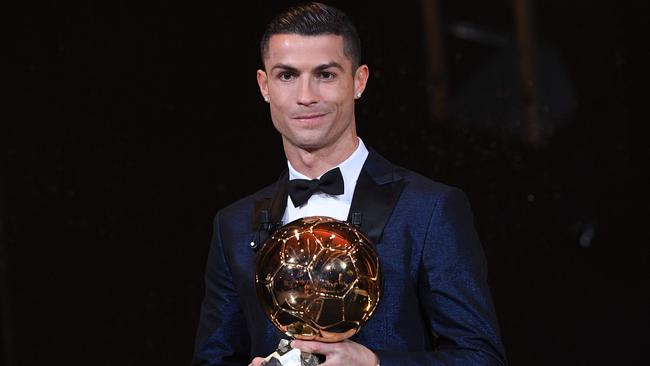 Cristiano Ronaldo posing with the Ballon d'Or France Football trophy in Paris. Picture: AFP.