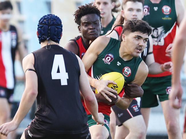 Saints' Frederic Thompson tackles Cutters' Mahkarni Mitchell-Corrie in the AFL Cairns Under 17B grand final match between the Cairns Saints and the South Cairns Cutters, held at Cazalys Stadium, Westcourt. Picture: Brendan Radke