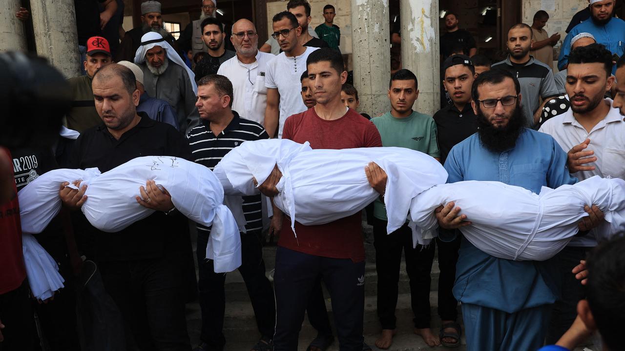 Relatives carry the bodies of children from the Abu Quta family who were killed in Israeli strikes on the Palestinian city of Rafah in the southern Gaza Strip, during their funeral on October 8, 2023. Picture: SAID KHATIB / AFP