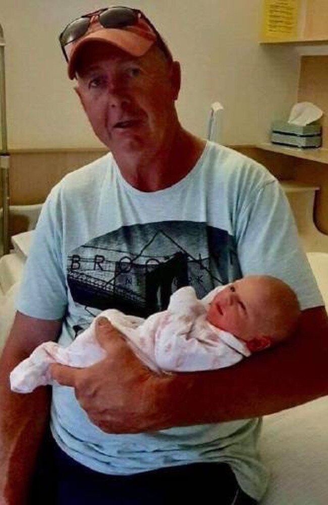 John Durie holding his newly born granddaughter Grace.