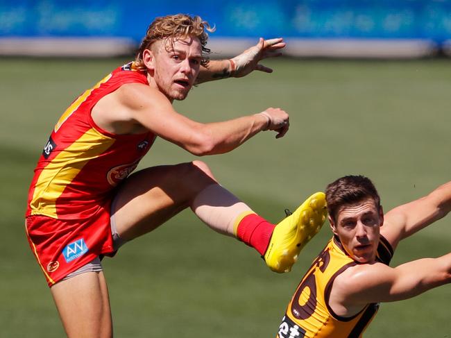 ADELAIDE, AUSTRALIA - SEPTEMBER 20: Hugh Greenwood of the Suns kicks the ball past James Cousins of the Hawks during the 2020 AFL Round 18 match between the Hawthorn Hawks and the Gold Coast Suns at Adelaide Oval on September 20, 2020 in Adelaide, Australia. (Photo by Matt Turner/AFL Photos via Getty Images)