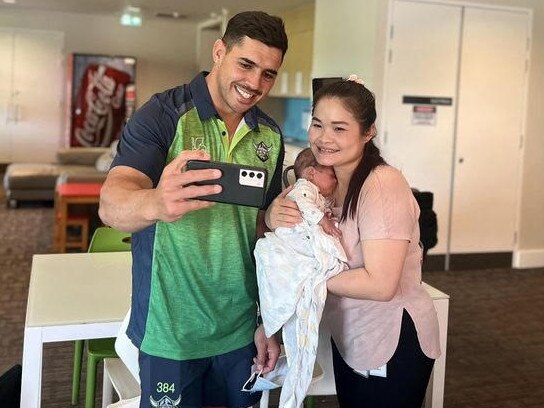 Raiders halfback Jamal Fogarty does a selfie with local mum Mu Dah and her baby at Ronald McDonald House in Canberra. Picture: Supplied