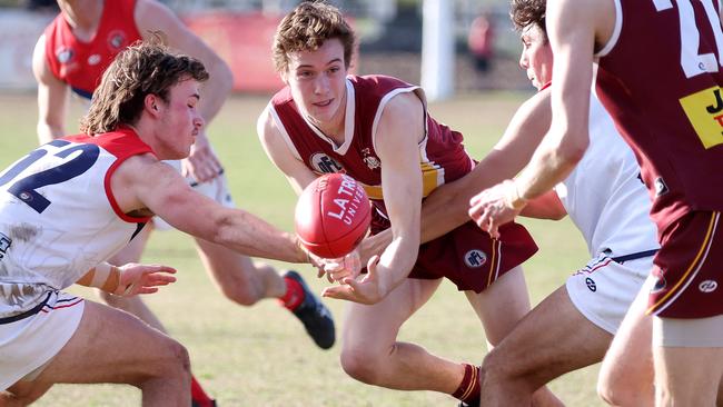 NFL: Alexander Alderton of Lower Plenty fires out a handball. Picture: George Sal