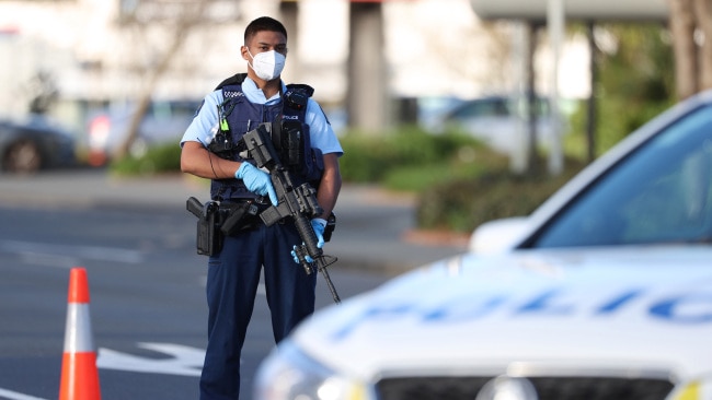 An armed police officer is seen outside the LynnMall Countdown in New Lynn, New Zealand, on Friday afternoon after six people were stabbed. Picture: Getty Images