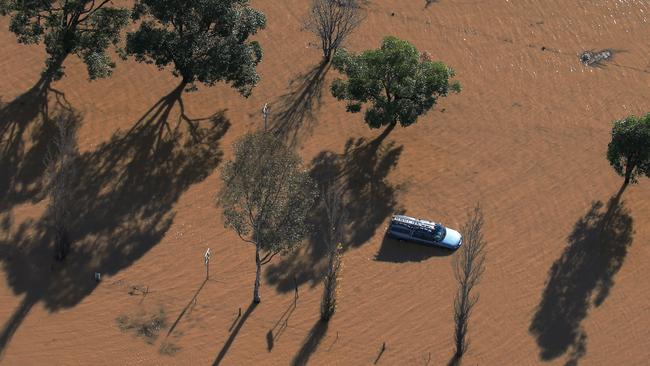 A ute sits submerged in flood waters on Cawdor Rd near Camden in Sydney’s southwest. Picture: Toby Zerna