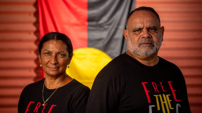 Nova Peris and Michael Long stand with the Aboriginal flag at Gardens Oval, Darwin ahead of the AFL's Dreamtime Round. Picture: Che Chorley