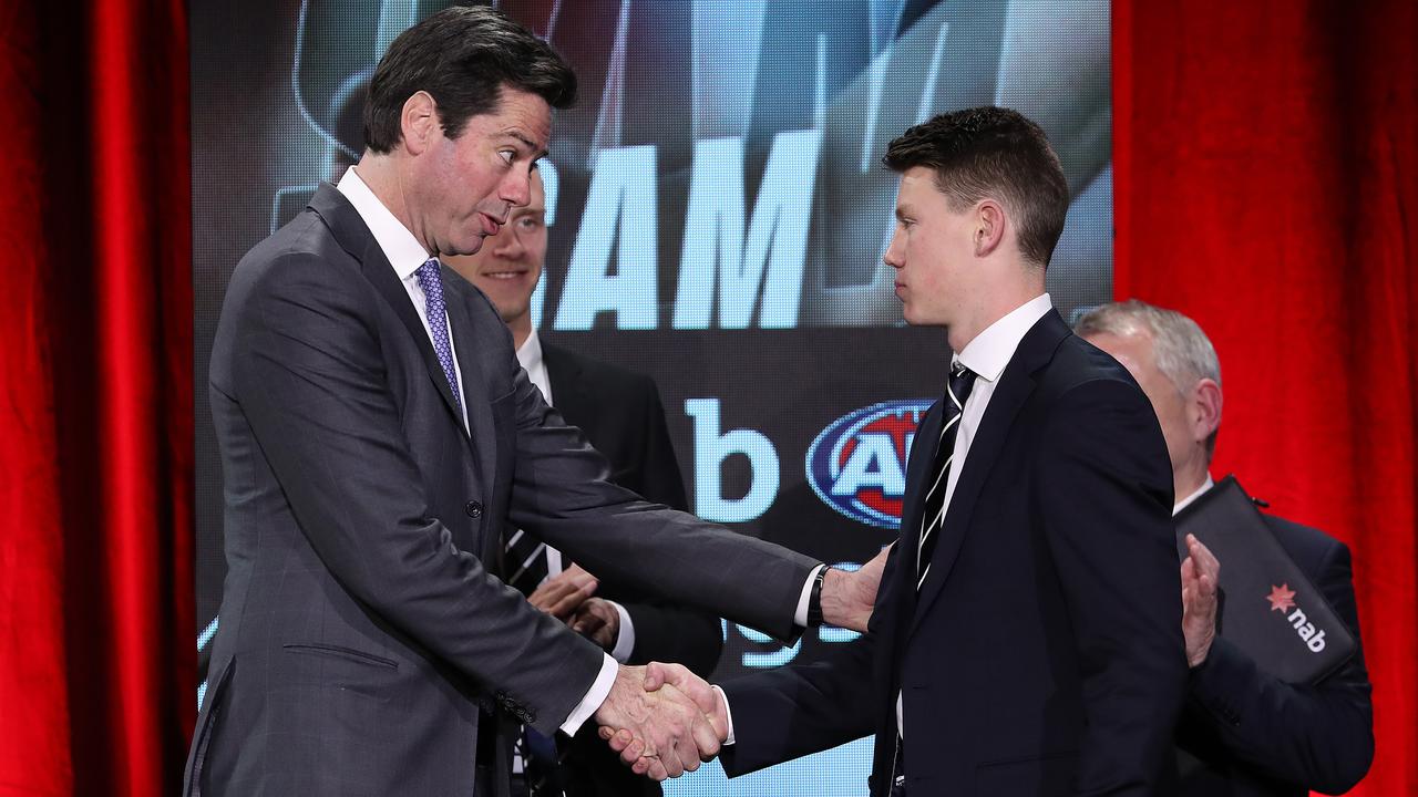 AFL CEO Gillon McLachlan congratulates Rising Star winner Sam Walsh on Friday.