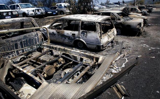 Burnt out cars in front of Acacia Prison.