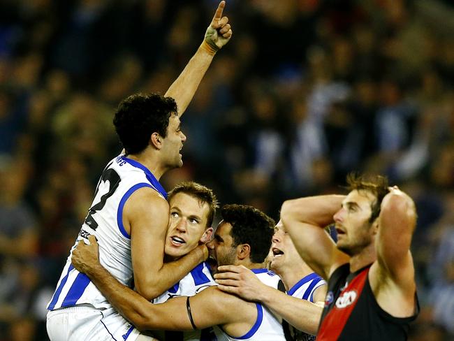 Drew Petrie is mobbed by his teammates after kicking his second goal in the final term.