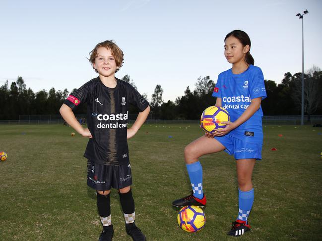 Eli May, 8, and Kayla Nguyen, 10, at soccer training in Carrara. Picture: Tertius Pickard