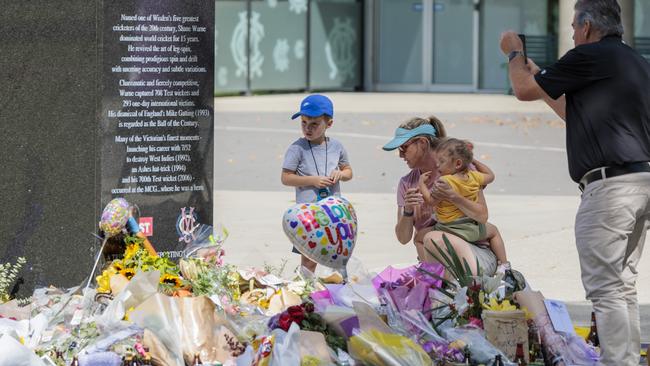 People tributes to the Shane Warne statue at the MCG on Monday. Picture: NCA NewsWire / David Geraghty.