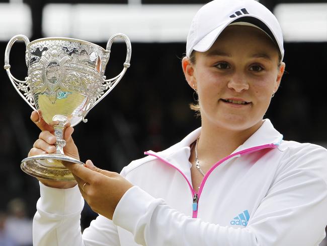 A 15-year-old Ash Barty with the junior Wimbledon trophy. Picture: AP