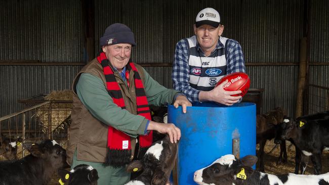 Dairy farmers Bernie Darcy and Simon Morris from Cobden showing their loyalties ahead of the match between Geelong and Essendon on Friday. Picture: Zoe Phillips