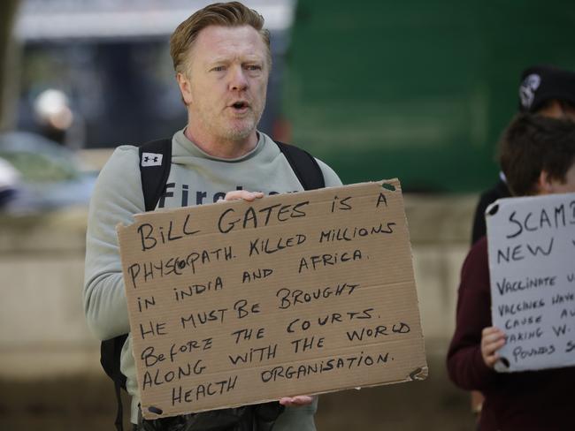 A man holds up an anti-Bill Gates placard at a coronavirus anti-lockdown, anti-vaccine, anti-5G and pro-freedom protest near Scotland Yard, the headquarters of London's Metropolitan Police Service, in London. Picture: AP