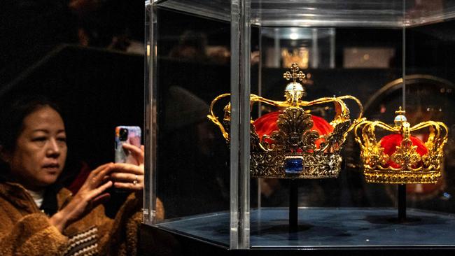 A visitor looks at Christian V's Crown (left) and The Queen's Crown displayed at Rosenborg Castle in Copenhagen, on January 2. The monarch's crowns were last used at Christian VIII's anointing in 1840. Picture: Ida Marie Odgaard/Ritzau Scanpix/AFP