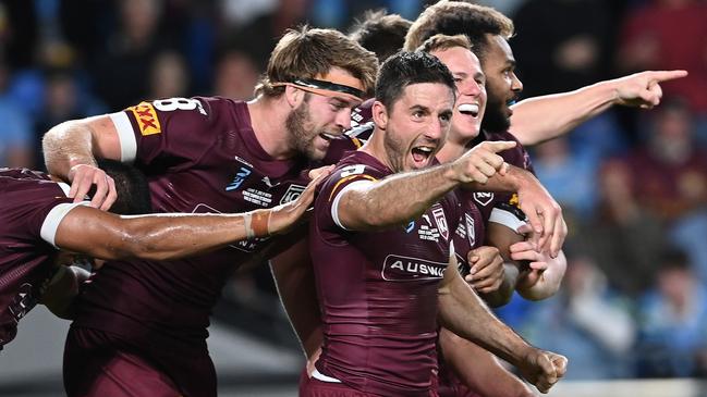 Ben Hunt of the Maroons celebrates with teammates after scoring his second try during against NSW at Cbus Super Stadium on the Gold Coast on Wednesday night. Picture: Getty Images