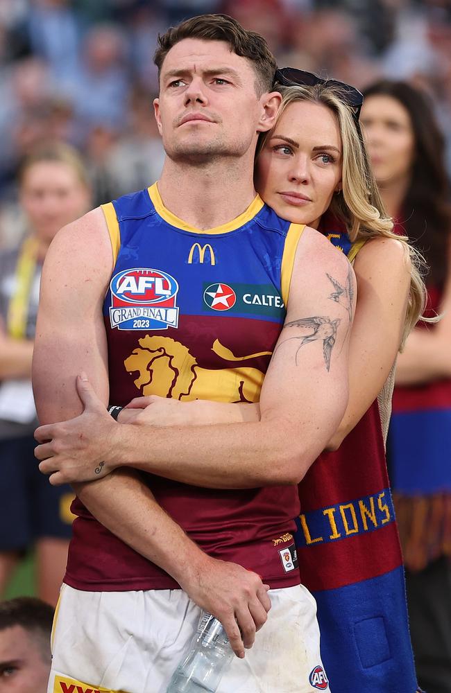 Lachie Neale of the Lions with wife Jules on the ground after the Grand Final. Photo by Robert Cianflone/AFL Photos/via Getty Images.