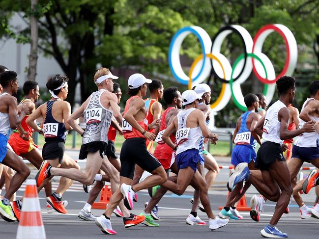 Runners move past the Olympic symbol in the men's marathon. Picture: AFP