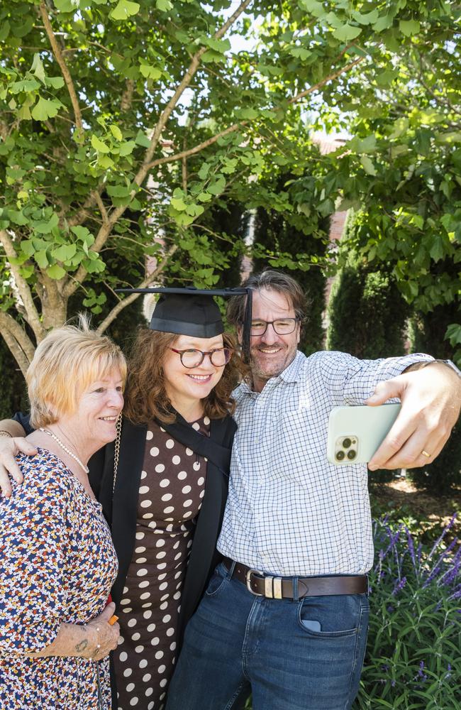 Graduate Fiona Stone with parents Jennifer Callaghan and Hugh Stone at a UniSQ graduation ceremony at Empire Theatres, Tuesday, October 31, 2023. Picture: Kevin Farmer