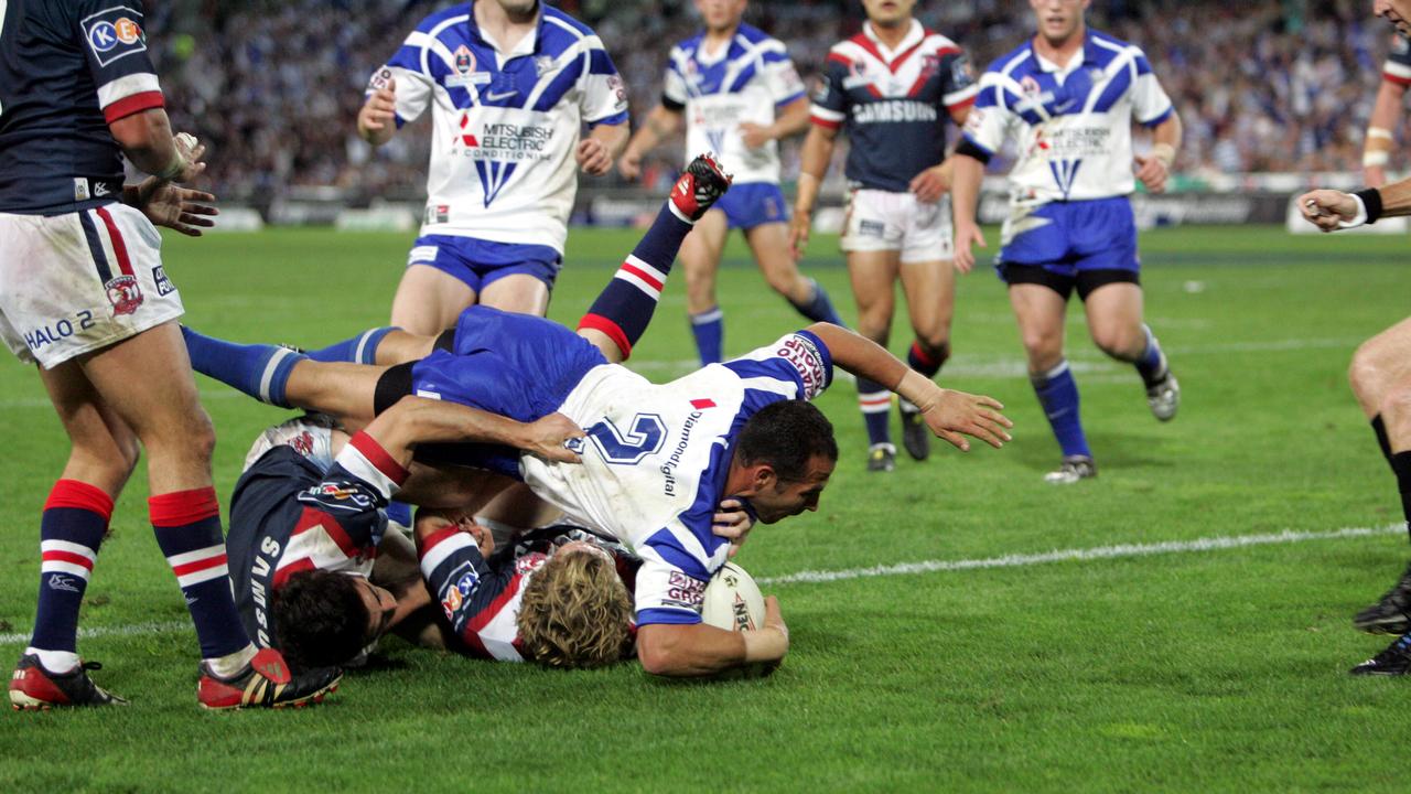 Hazem El Masri leaps over Anthony Minichiello and Ryan Cross to score.