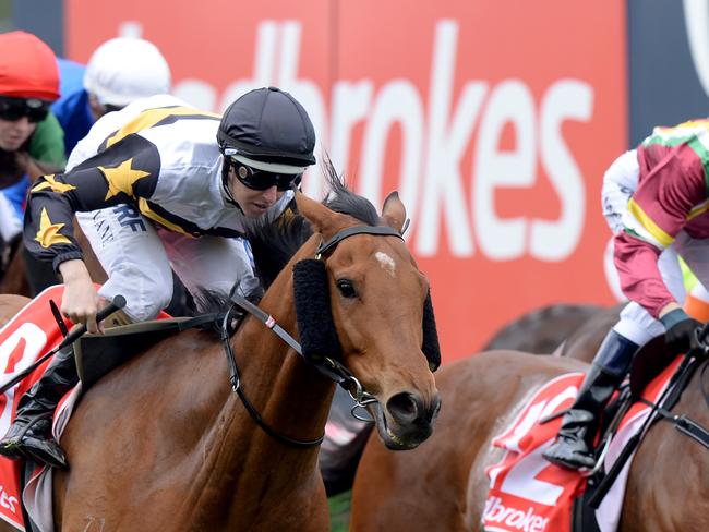 Jockey Damian Lane rides Cool Chap (second left) to victory in race 4, the Ladbrokes Up for the Challenge Handicap, on the Underwood Stakes Day at Caulfield Racecourse in Melbourne, Sunday, October 1, 2017. (AAP Image/Mal Fairclough) NO ARCHIVING, EDITORIAL USE ONLY