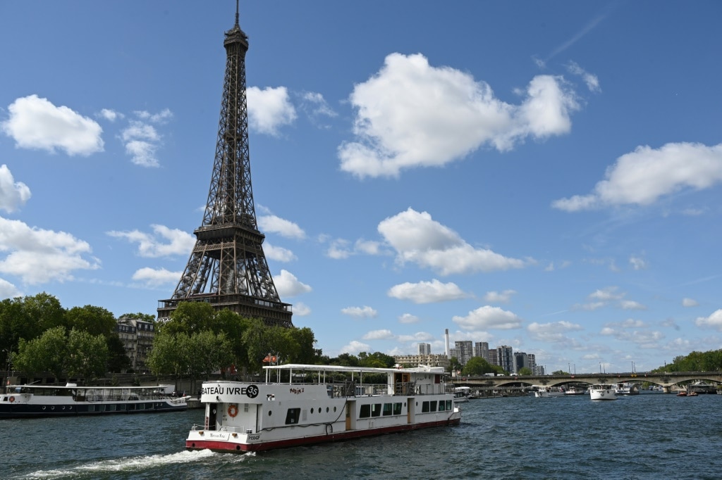 A boat sails past the Eiffel Tower on the River Seine during tests for the 2024 Olympics opening ceremony