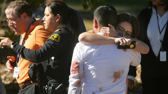 A couple embraces ... following  the mass shooting. Picture: David Bauman/The Press-Enterprise via AP