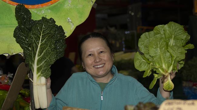 Service with a smile; Ann Chang with an abundance of fresh green affordable lettuce alternatives at her family stall at Rusty’s. Picture Emily Barker