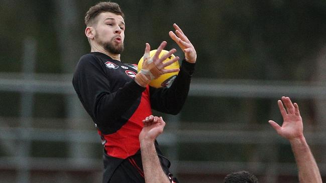 Tim Currie flies for a mark. Picture: Hamish Blair