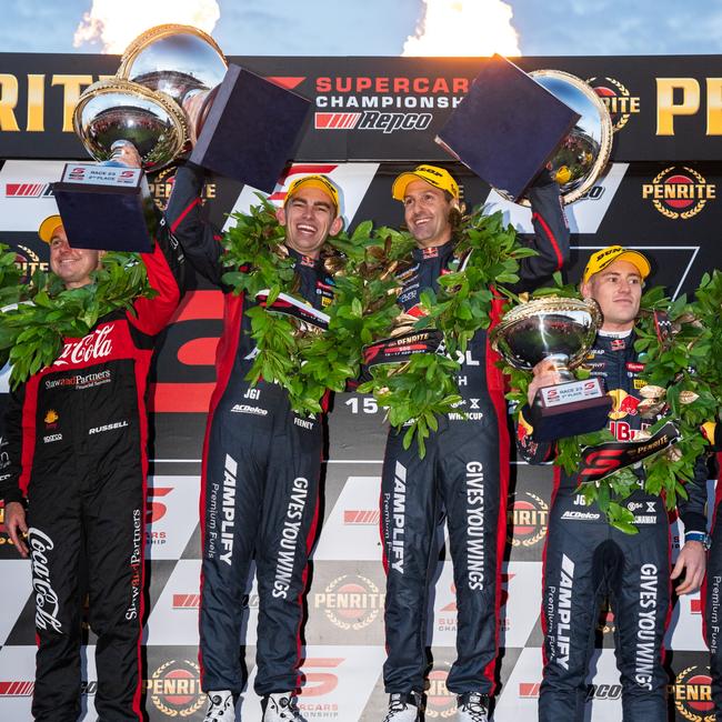 Broc Feeney and Jamie Whincup celebrate on the podium after winning the 2023 Sandown 500. (Photo by Daniel Kalisz/Getty Images)