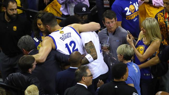 Andrew Bogut is assisted off the court after sustaining an injury during the third quarter against the Cleveland Cavaliers in Game 5 of the 2016 NBA Finals.