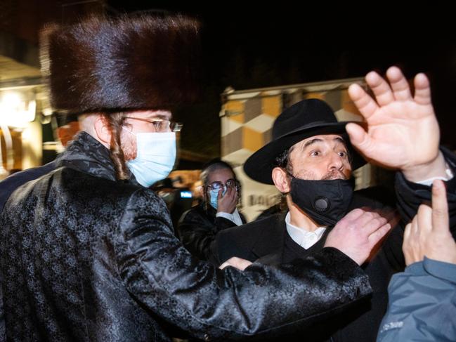 MELBOURNE, SEPTEMBER 7, 2021: Members of the Caulfield Jewish community remonstrate with the media as fellow community members are questioned by police as they leave an illegal gathering. Picture: Mark Stewart