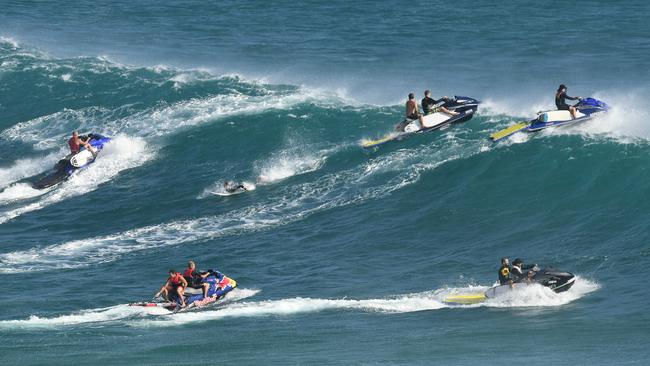 Jetski riders prepare to tow surfers on to waves at Kirra on the Gold Coast , Friday, February 22, 2019.  Huge swells and high tides are pummelling south-east Queensland beaches as Cyclone Oma sits off the Queensland coast. (AAP Image/Dave Hunt)