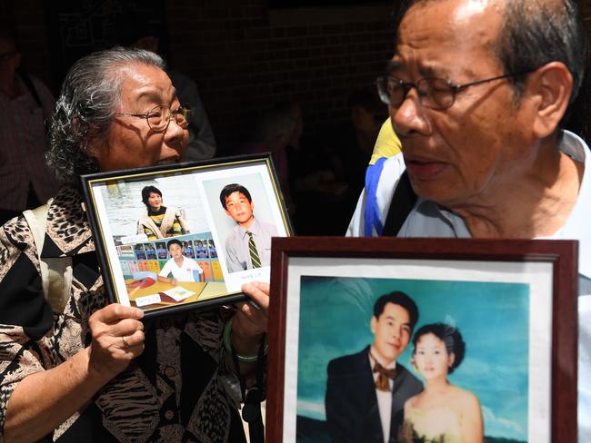 They carry images of their loved ones killed in the massacre. Picture: AAP Image/Paul Miller