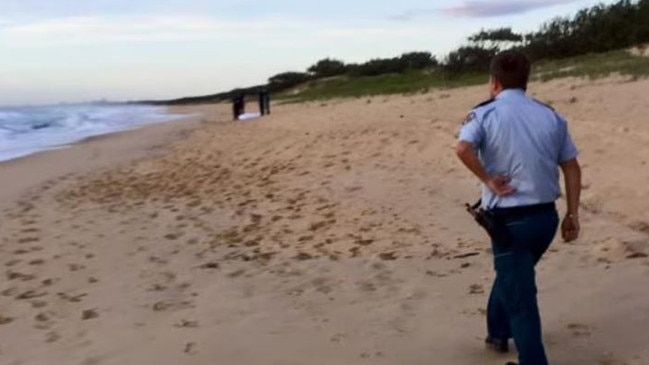 A picture taken of Mr Halgryn’s body covered in a sheet after he was discovered on the beach.