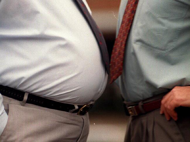 Overweight men with bulging stomachs over top of belt, more susceptible to cardiovascular problems, referred to as "Tight Pants Syndrome (TSS)". People / Fat / weight health medical 1996 beer gut belly obese