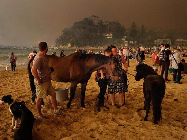 Bushfire arrives into the township of Malua Bay NSW, just south of Batemans Bay. New Years Eve.  Locals waiting for the fires to arrive on the designated evacuation site of the beach.   Picture: Alex Coppel.