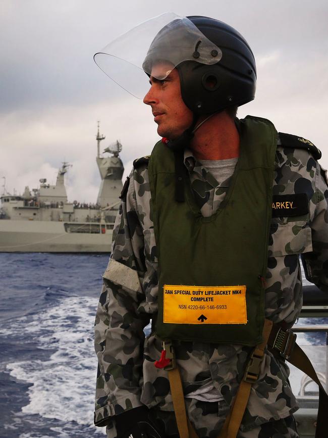 Leading Seaman, Boatswain's Mate, William Sharkey looks for debris as HMAS Perth conducts a search for MH370 in April 2014. Picture: AFP