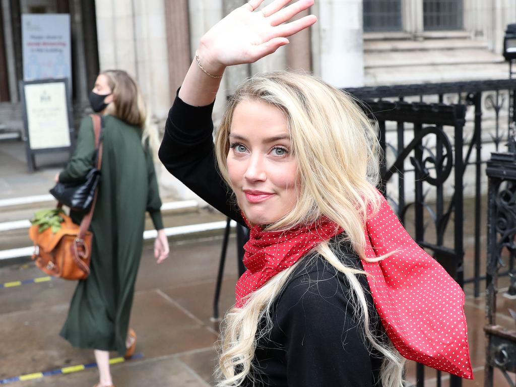 Amber Heard was all smiles outside court. Picture: ISABEL INFANTES / AFP.