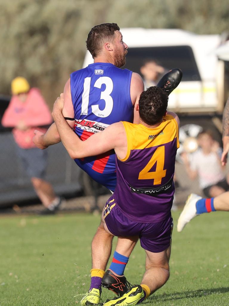 Bell Post Hill's Scott Hughes gets a kick out under pressure from Thomson's Travis McGuire. GDFNL - Bell Post Hill v Thomson. Picture: Alan Barber