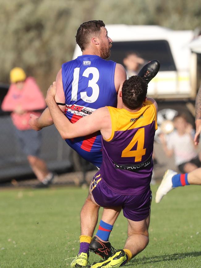 Bell Post Hill's Scott Hughes gets a kick out under pressure from Thomson's Travis McGuire. GDFNL - Bell Post Hill v Thomson. Picture: Alan Barber