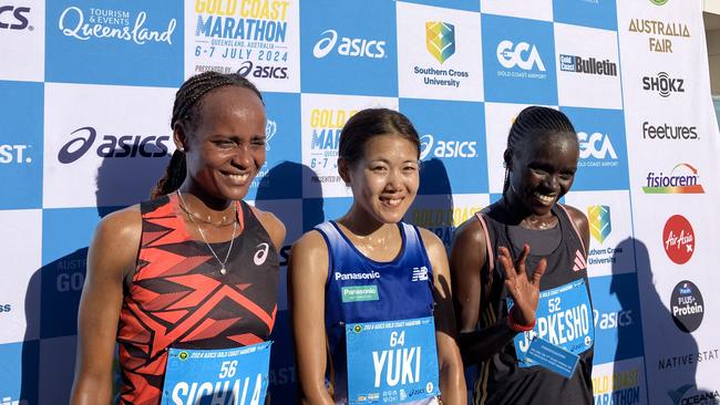 Yuki Nakamura, Kumeshi Sichala and Visiline Jepkesko finish first, second and third in the Gold Coast Marathon. Photo: Mitch Bourke