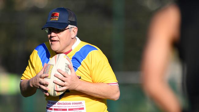 Prime Minister Scott Morrison joins a rugby league drill with students from the Clontarf Academy at Endeavour Sports High School on Thursday.