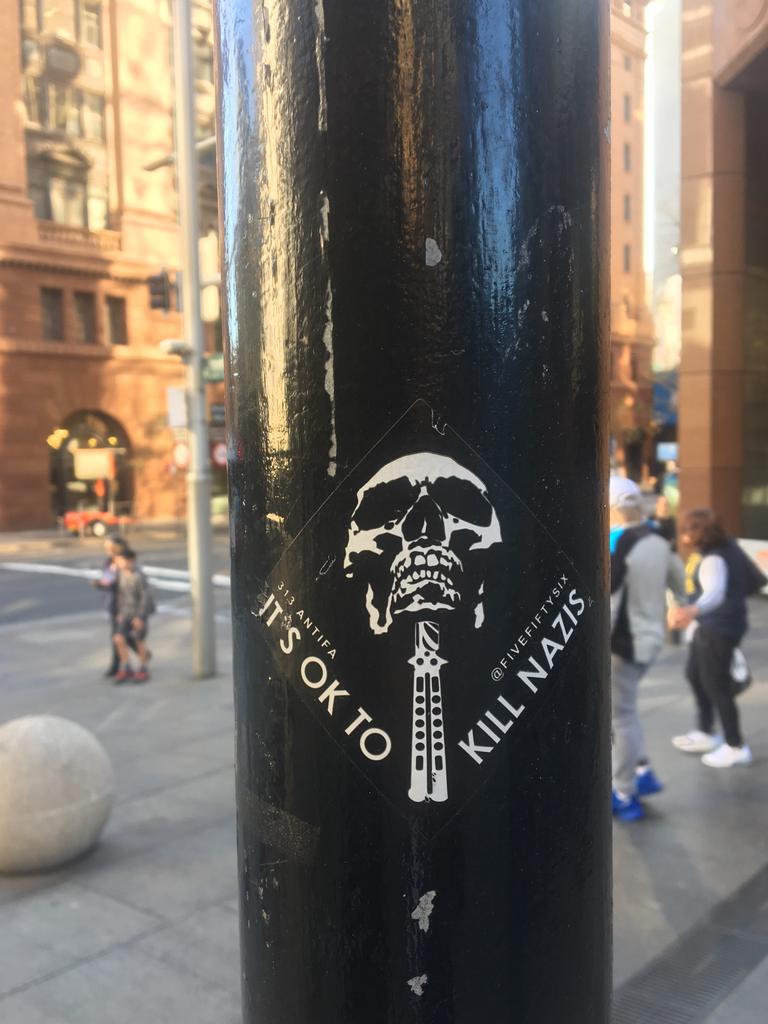 ASIO and the AFP have warned of a proliferation of banners, flags and stickers promoting extremist right and left wing views such as these in Sydney's CBD. Picture: Charles Miranda