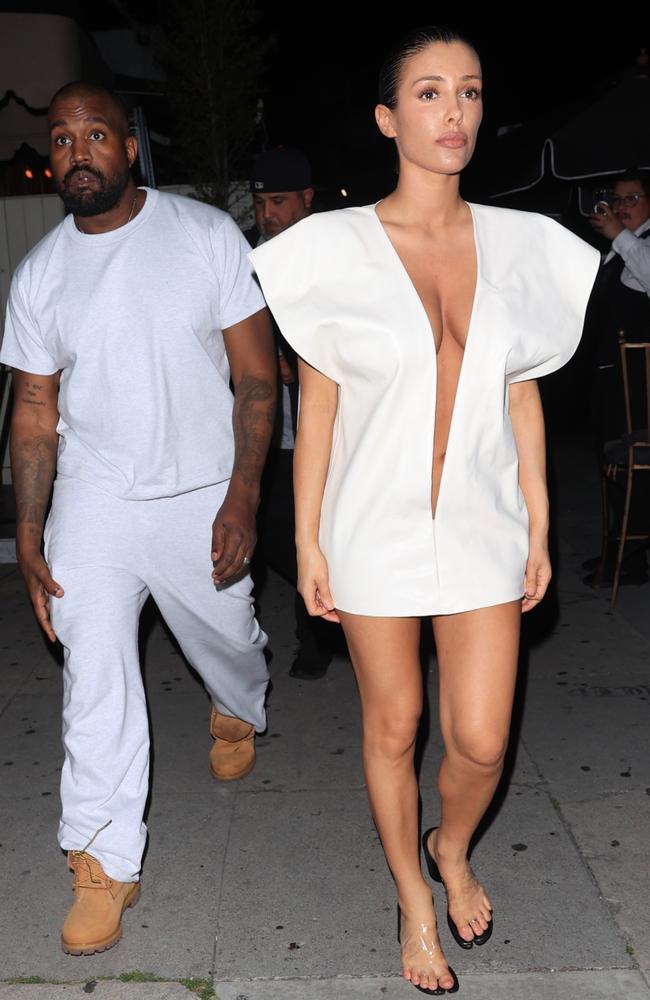 Ms Censori paired the white dress with clear sandals. She was accompanied by Ye, who wore an all-white outfit consisting of a T-shirt, jeans and Timberland boots. Picture: ShotbyNYP / BACKGRID