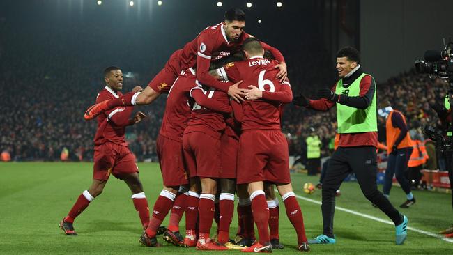 Liverpool's German midfielder Emre Can (L) jumps into the celebration for the third Liverpool goal scored by Liverpool's Senegalese midfielder Sadio Mane.