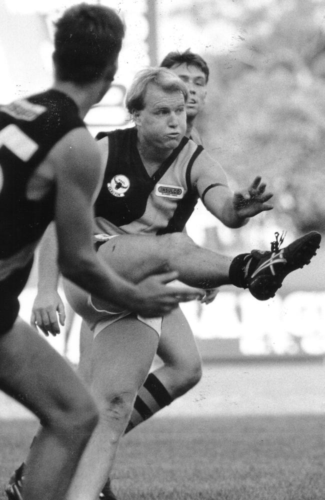 Tigers centre man Kerry Brain pumps the ball downfield at Football Park during a match in November, 1993.